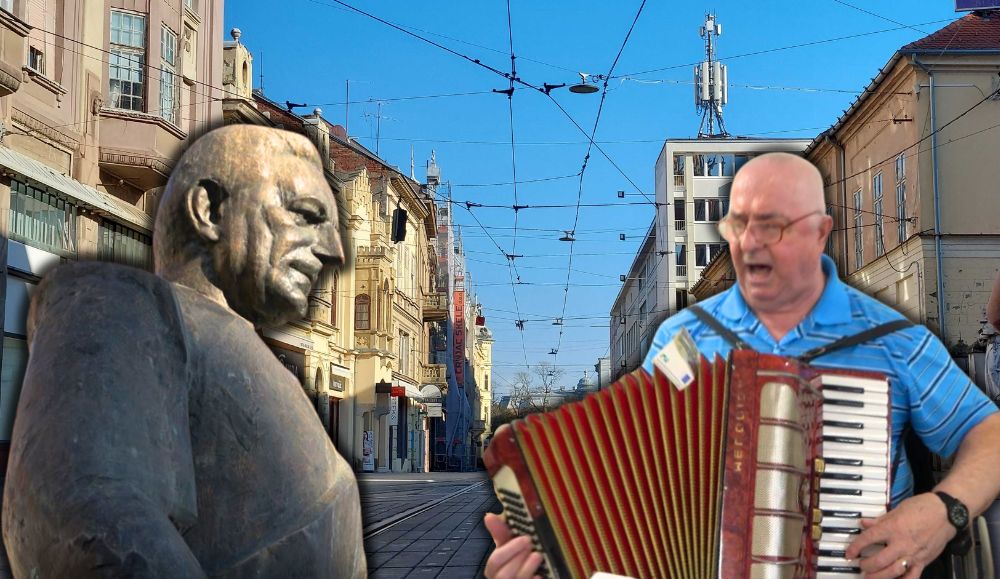u pozadini ulica u centru Osijeka, kip Tuđmana i čovjek s harmonikom